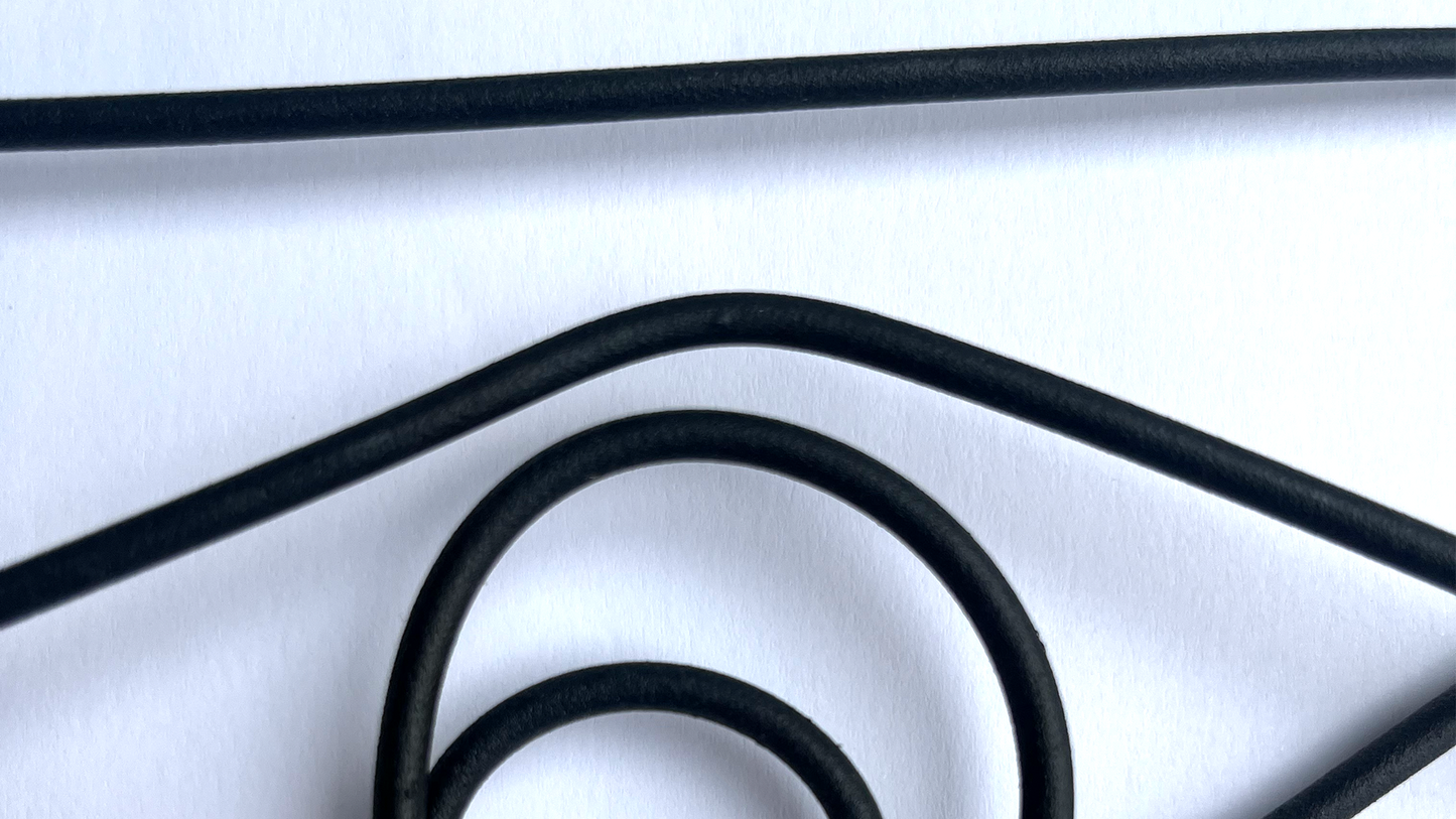 a close up image of black bent powder coated black steel wall art on white background with shadows