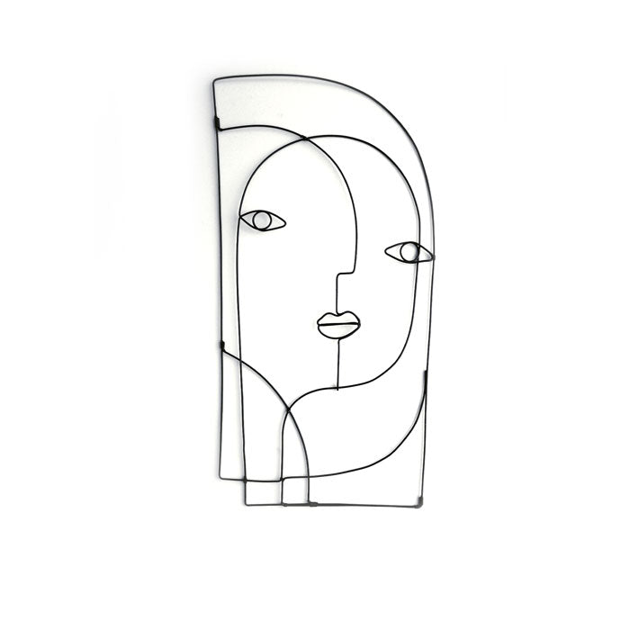 This piece of abstract steel wall art by Living Things Creative, made from black hand-bent steel, showcases an abstract face with geometric features, such as prominent eyes and a stylized mouth, all set against a simple white background.